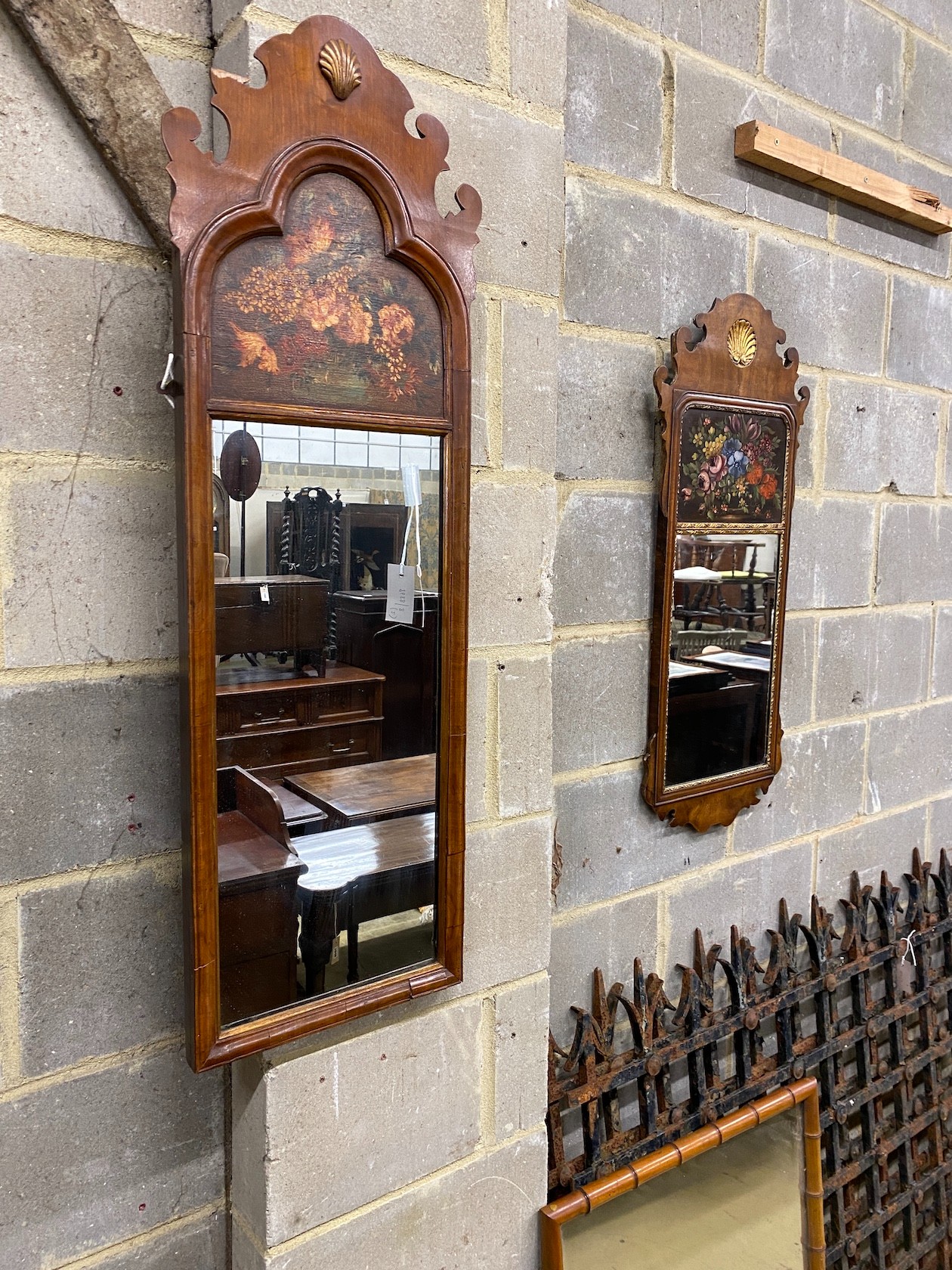 Two 18th century style painted walnut fret cut wall mirrors, larger width 35cm, height 110cm